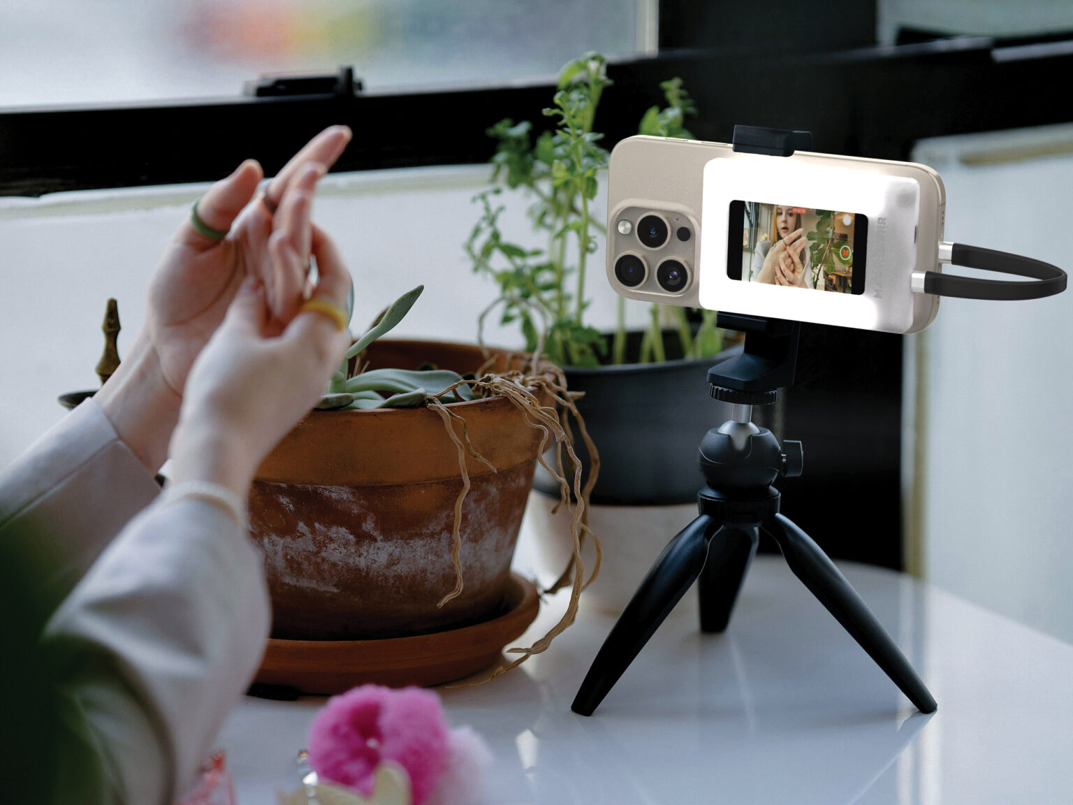 MagMirror mounted on a phone and tripod, mirroring the rear camera's live preview on its built-in display